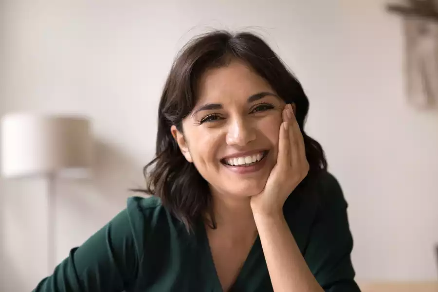 Happy, smiling woman in a comfortable, relaxed pose